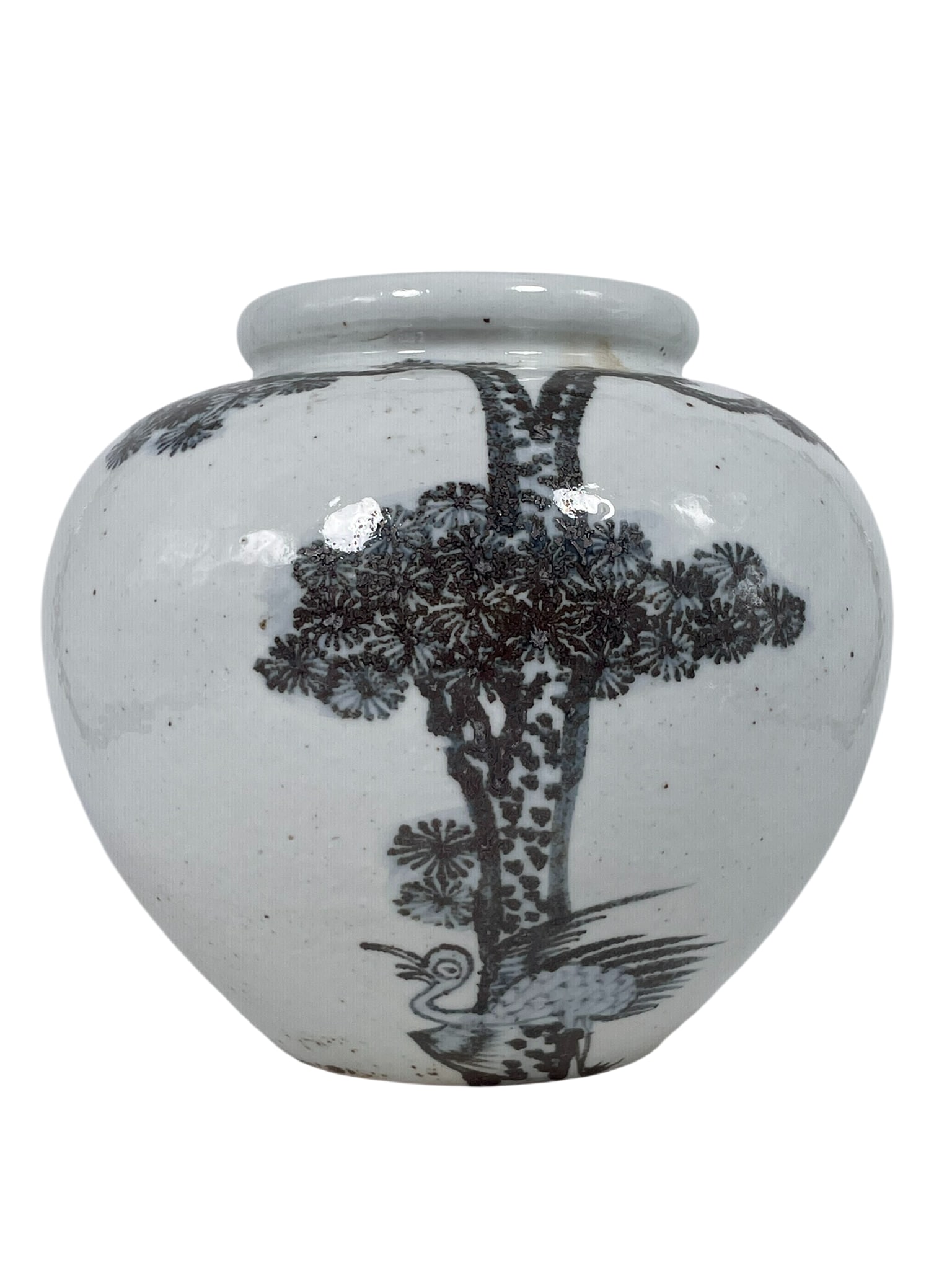 A Korean 'Pine Tree' Porcelain Moon Jar: 9 in. high, 10 in. wide.