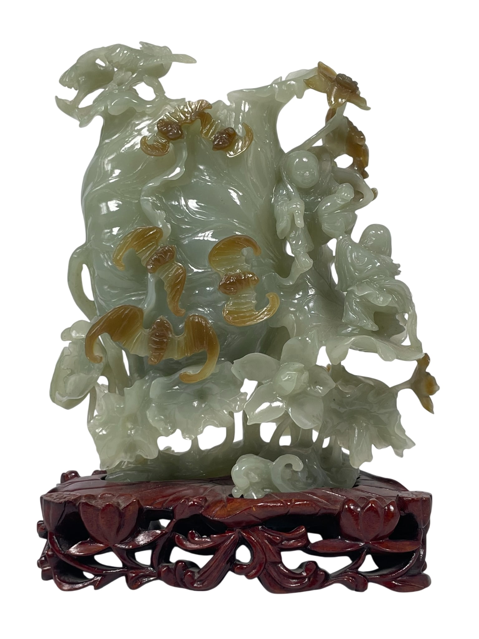 A Chinese Jade Carving of 'Boys and Bats': With a wood stand, 8.3/4 in. high, 6.1/4 in. wide overall including the stand.
