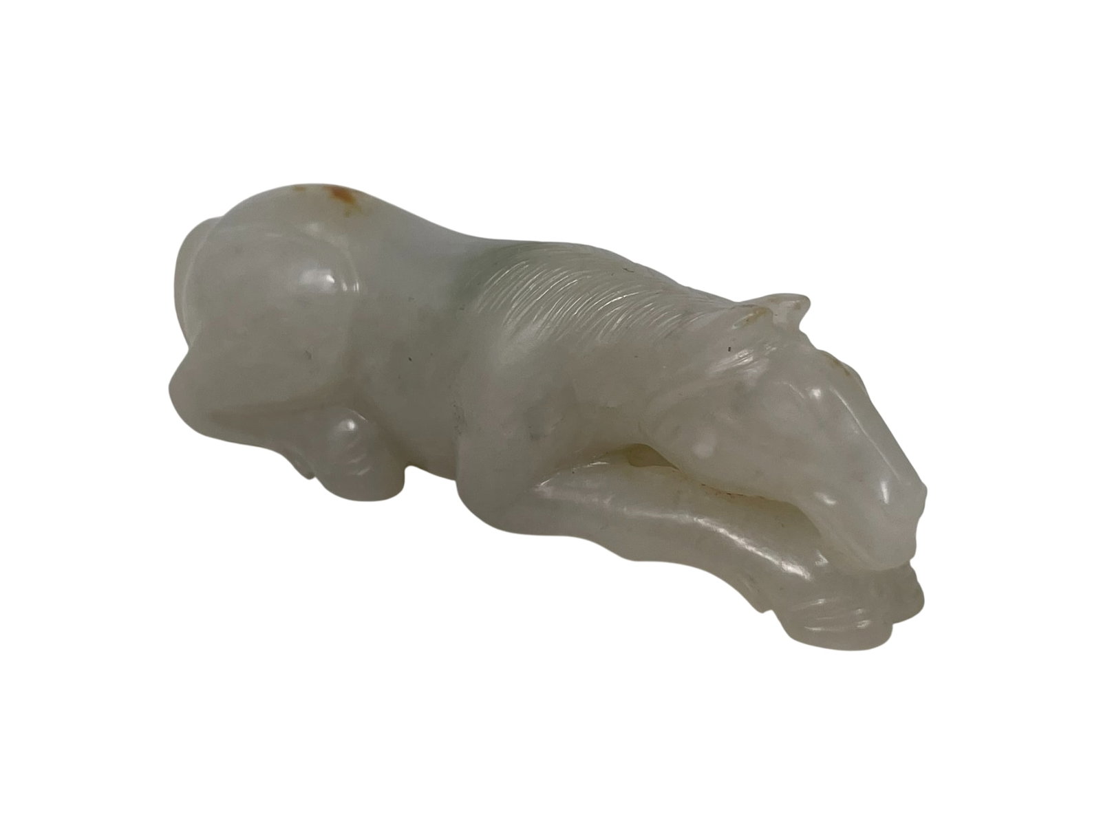 A Chinese White and Russet Jade Carving of a Recumbent Horse: 7/8 in. high, 2.3/4 in. wide.