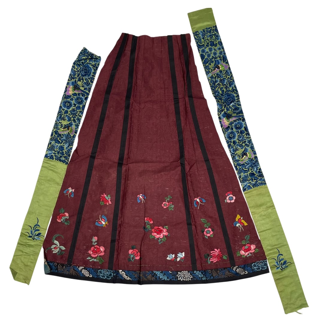 A Group of Three Chinese Embroidered Silk Objects: Comprising a skirt hem and two belts, with the skirt hem measures 30 in. long, 27 in. wide.