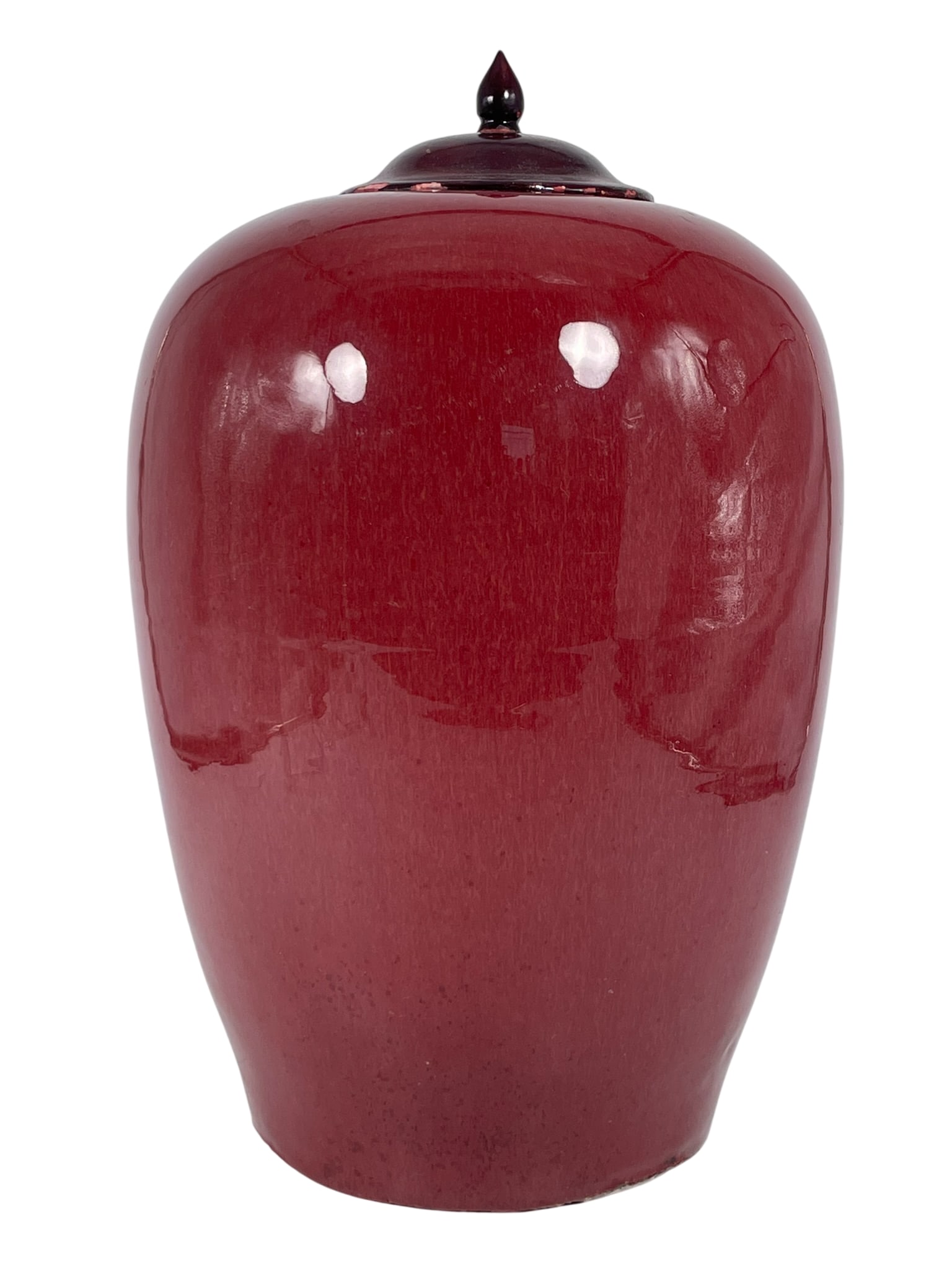 A Chinese Red-Glazed Porcelain Jar and a Wood Cover, Qing Dynasty: 13.3/4 in. high, 8.1/2 in. wide overall.