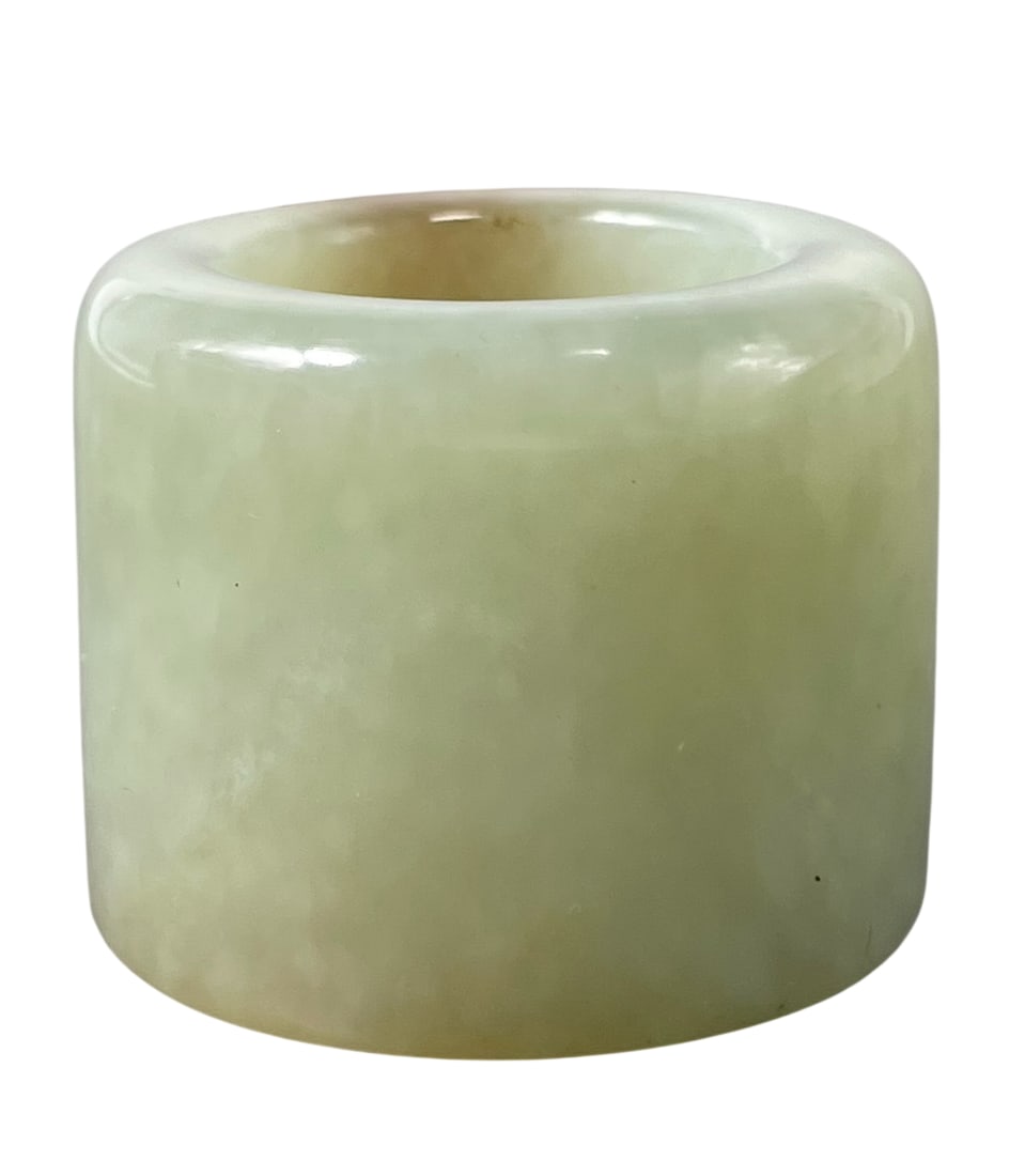 A Chinese White and Russet Jade Archer's Ring: 1.1/8 in. wide, 1.3/8 in. diam.