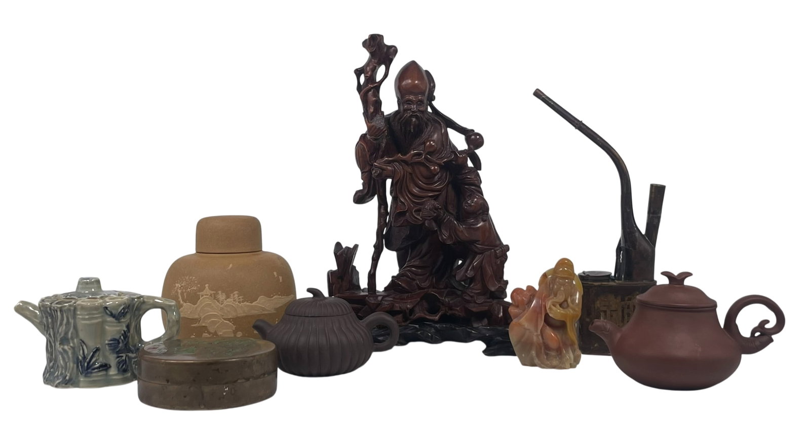 A Group of Eight Chinese Decorative Objects: Comprising two Yixing pottery teapots and covers, one with a mark 'Wang Yingxian', 3.1/2 in. high, 5.3/4 in. wide; one with a mark 'Zhou Guizhen', 2.3/4 in. high, 4.1/2 in. wide; a porcelain teapot an