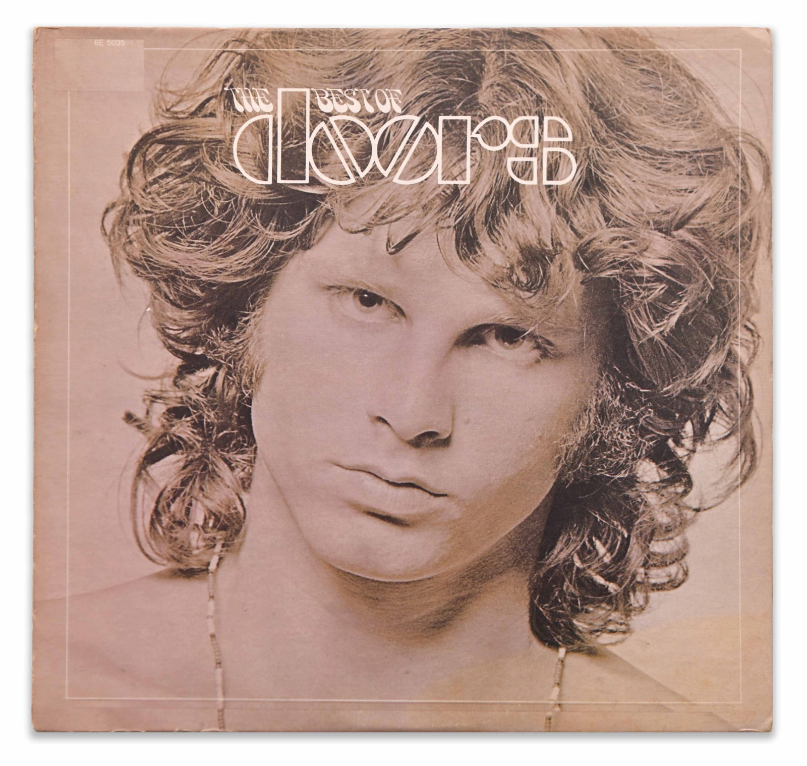 THE DOORS - The Best of the Doors (Elektra Records, 6E-5035): The lot consists of a copy of The Best of the Doors, a well-known compilation album featuring a striking close-up portrait of Jim Morrison rendered in soft sepia tones beneath the group's distinctive 
