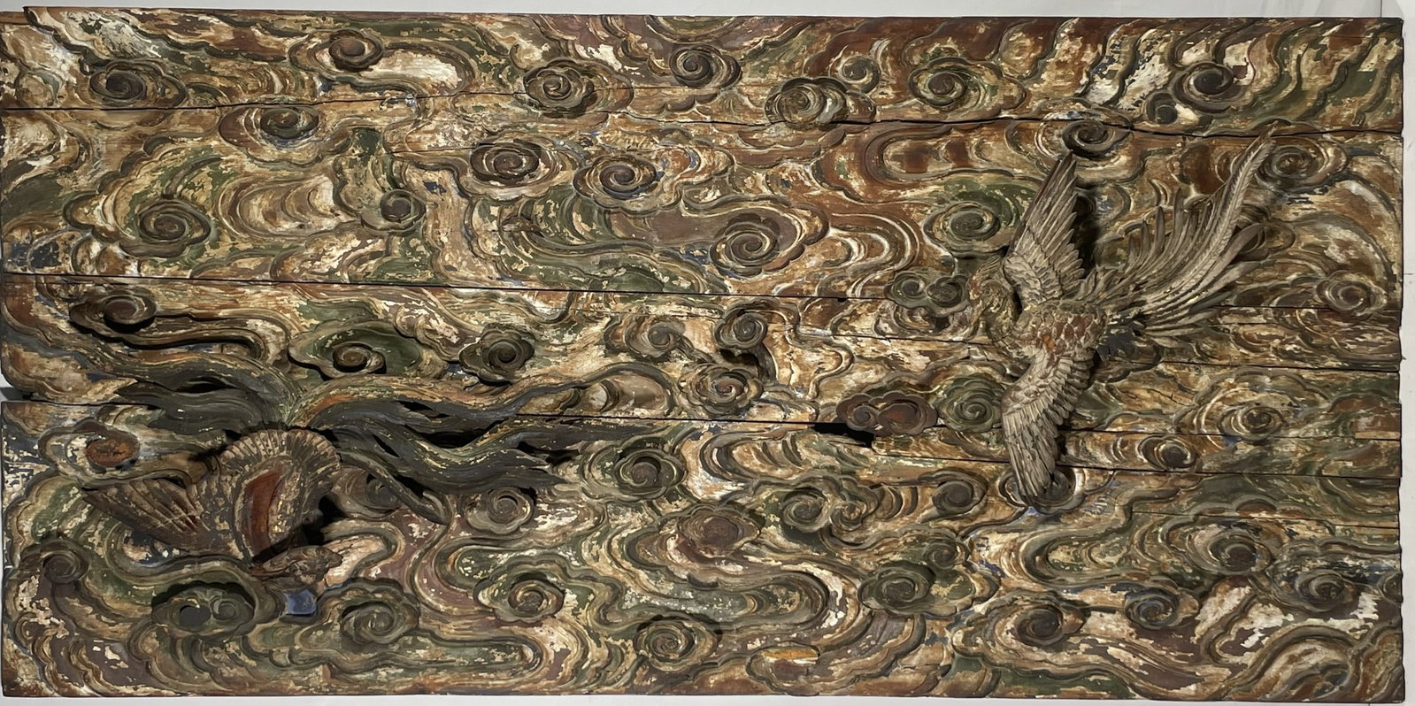 A Large Carved Decorative Wood Panel: Features a high-relief mythological bird and swirling cloud motif. 74 in. x 36 in.
