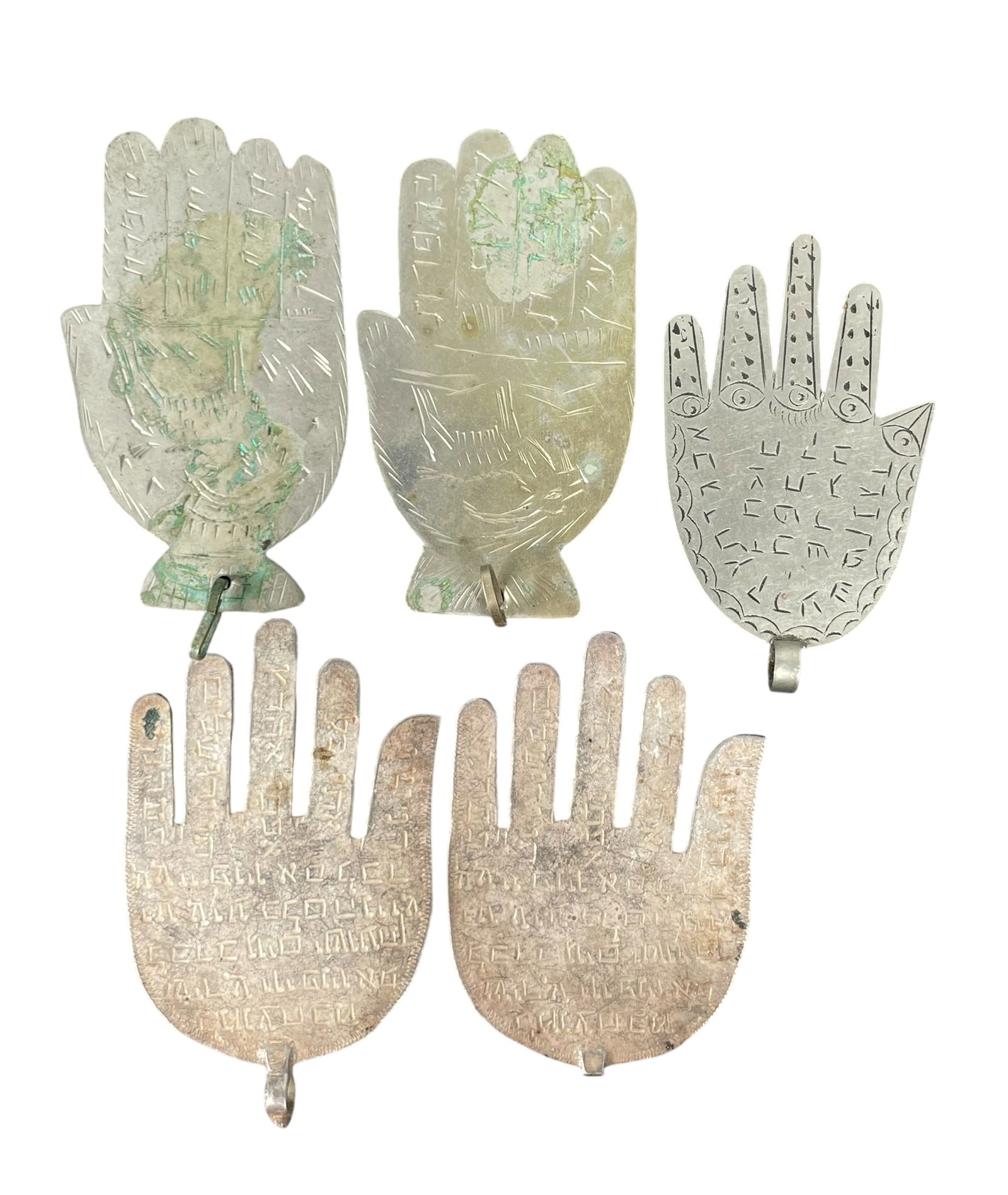 A Group of Five Metal Hamsa Amulets