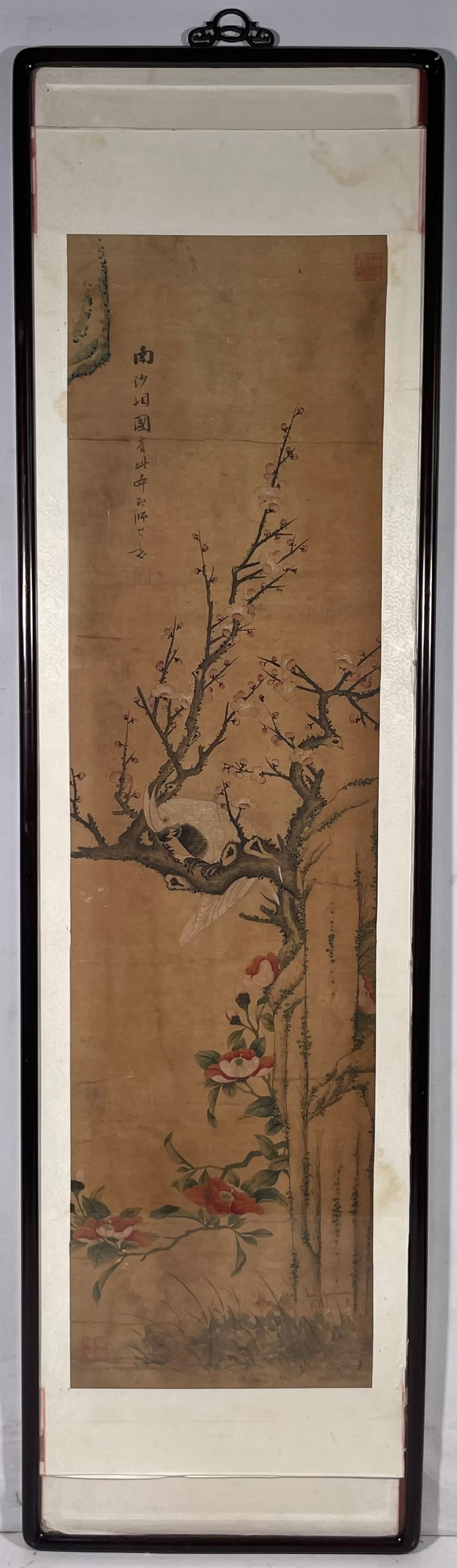 A Chinese Painting of Parrot and Plum Blossom: Ink and color on paper, 54 in. x 14.1/2 in. for the painting, 70 in. x 15.1/2 in. overall including the frame.