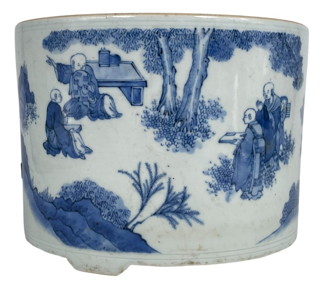 A Chinese Blue and White 'Buddhist Monks' Porcelain Tripod Censer, Kangxi Period, Qing Dynasty: With an illegible Freeman's sticker to the bottom. 6 in. high, 8 in. diam.