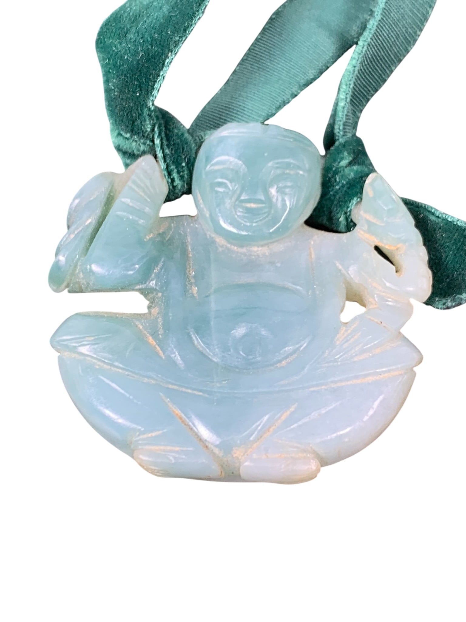 A Chinese Carved Green Jade 'Buddha' Pendant: 1.5/8 in. high, 1.5/8 in. wide.