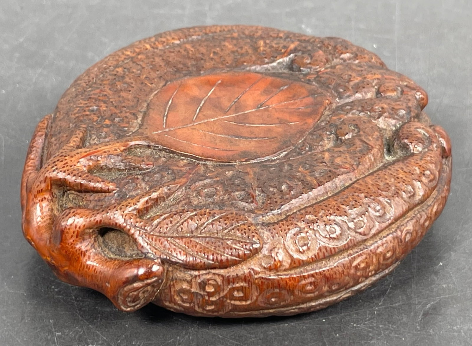 A Japanese Carved Bamboo Paper Weight: 3.1/2 in. long, 3.1/4 in. wide.