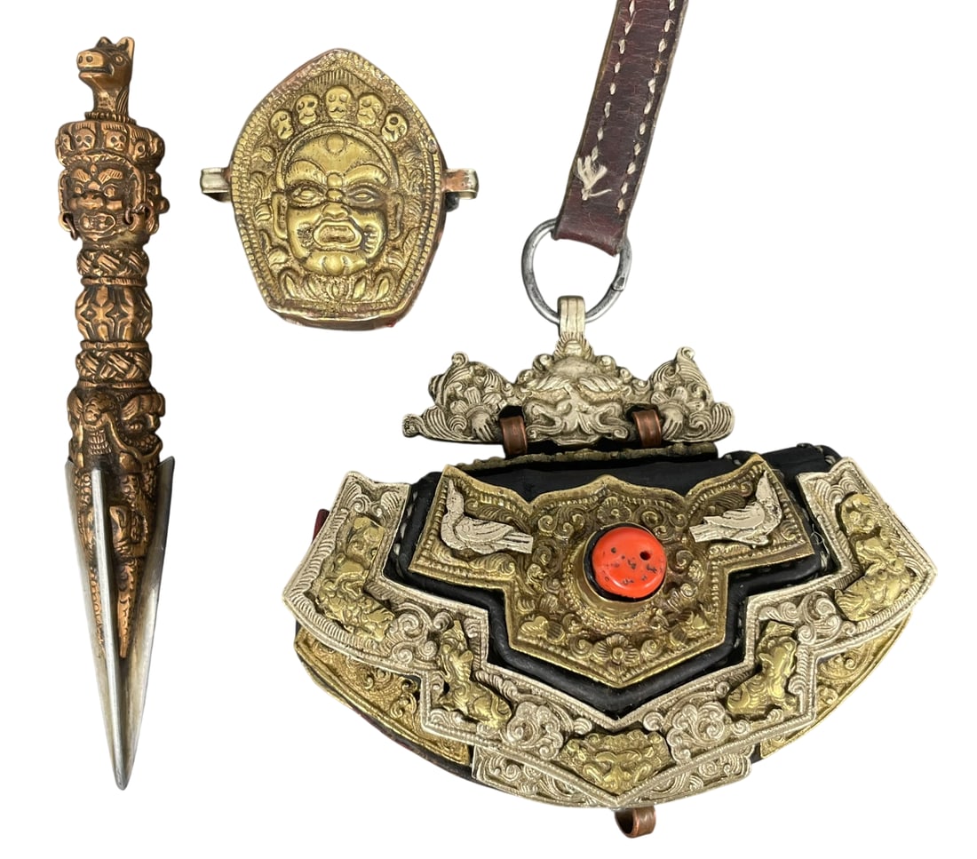 A Group of Three Tibetan Ritual Objects: Comprising a brass and leather flint pouch, 5 in. long, 3 in. wide; a brass Gau box, 2.1/4 in. long, 2.1/4 in. wide; and a bronze phurba, 6.1/4 in. long.