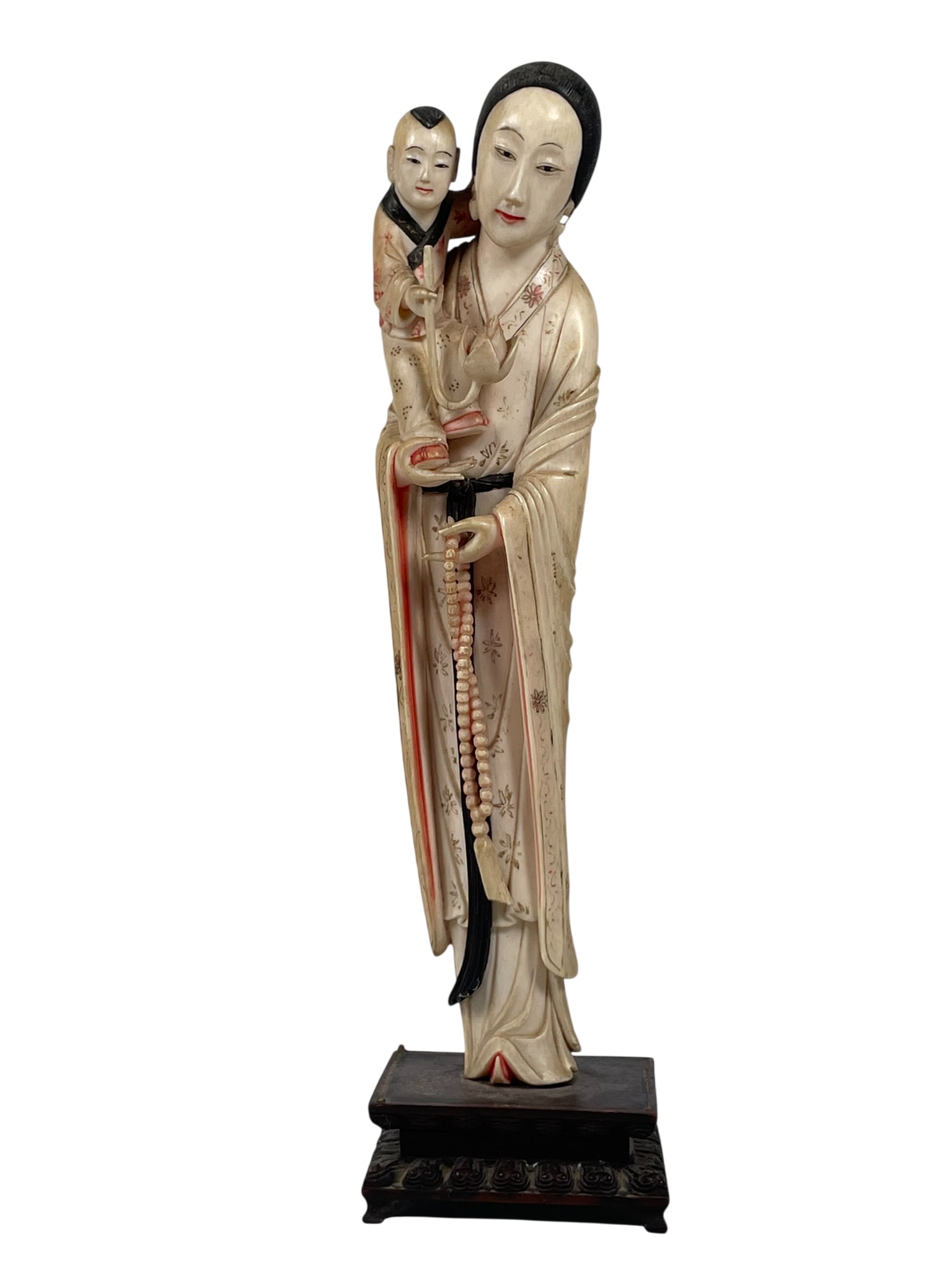 A Chinese Handcrafted Decorative Figure of Guanyin Holding a Child: Mounted on a wood stand. 11 in. high, 2.7/8 in. wide overall.