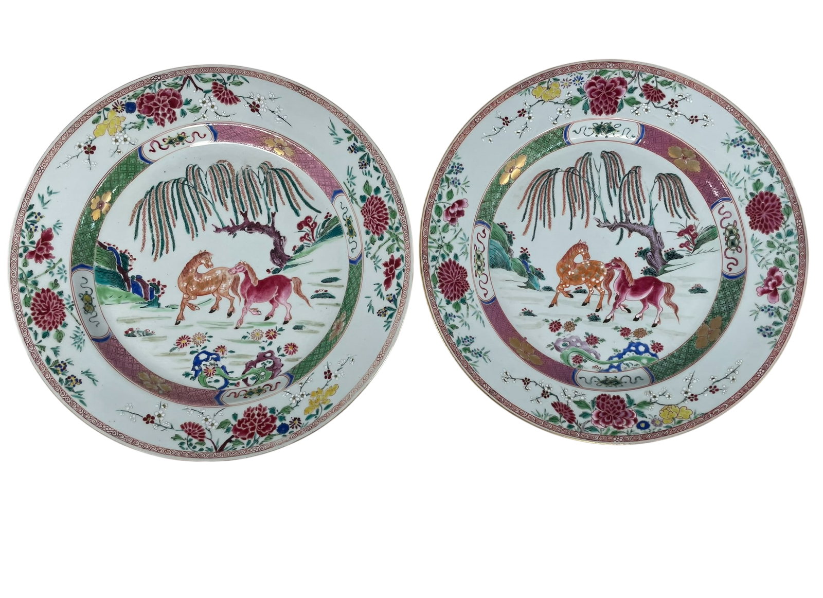 A Pair of Chinese Famille Rose 'Horses' Chargers, Yongzheng Period, Qing Dynasty: 15.3/8 in. diam. each.
