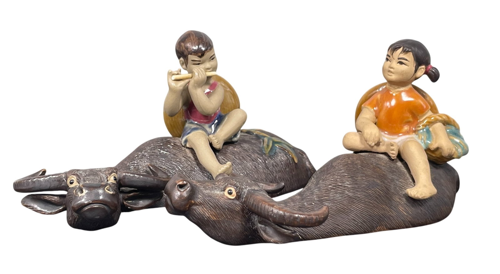 A Pair of Chinese Pottery Figural Group of Children and Buffalos: 2.7/8 in. high, 5.3/8 in. wide each.