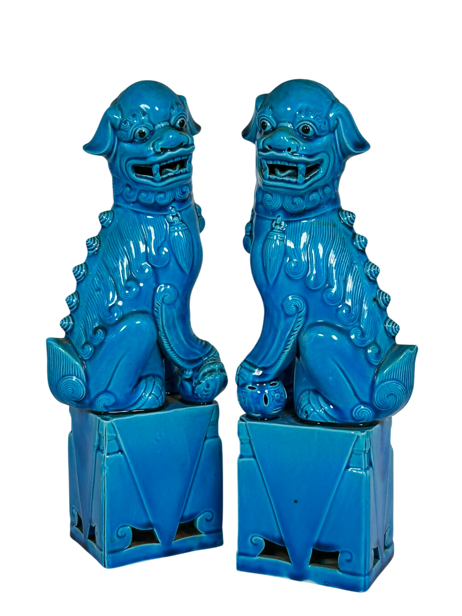 A Pair of Chinese Turquoise-Glazed Porcelain Figures of Buddhist Lions: 12 in. high, 4.1/2 in. wide each.