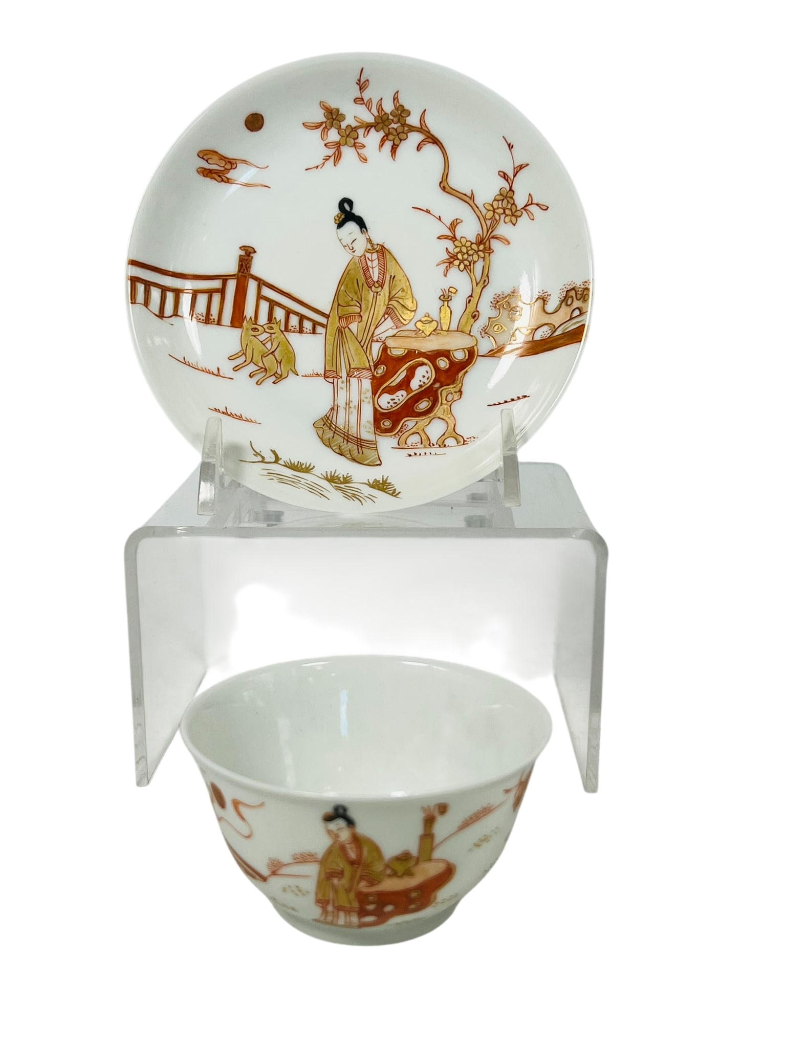 A Chinese Iron-Red and Gilt-Decorated 'Figural' Porcelain Cup and Saucer Set, Qing Dynasty: 4.1/4 in. diam. for the saucer, 2.3/4 in. diam. for the cup.