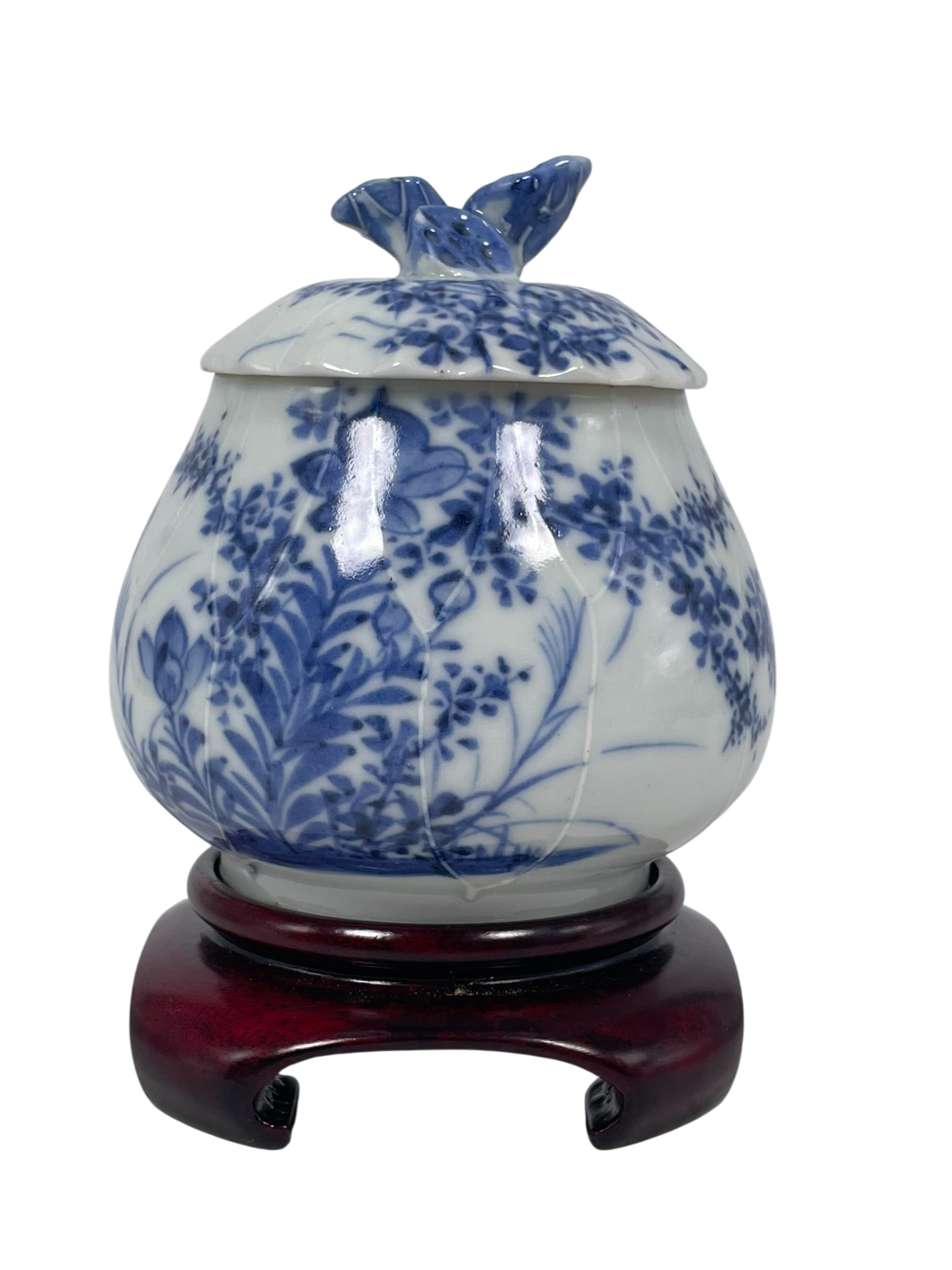 A Chinese Blue and White Bud-Form Jar and Cover, Qing Dynasty: With a wood stand. The jar and cover measures 3.7/8 in. high, 3.3/4 in. wide.