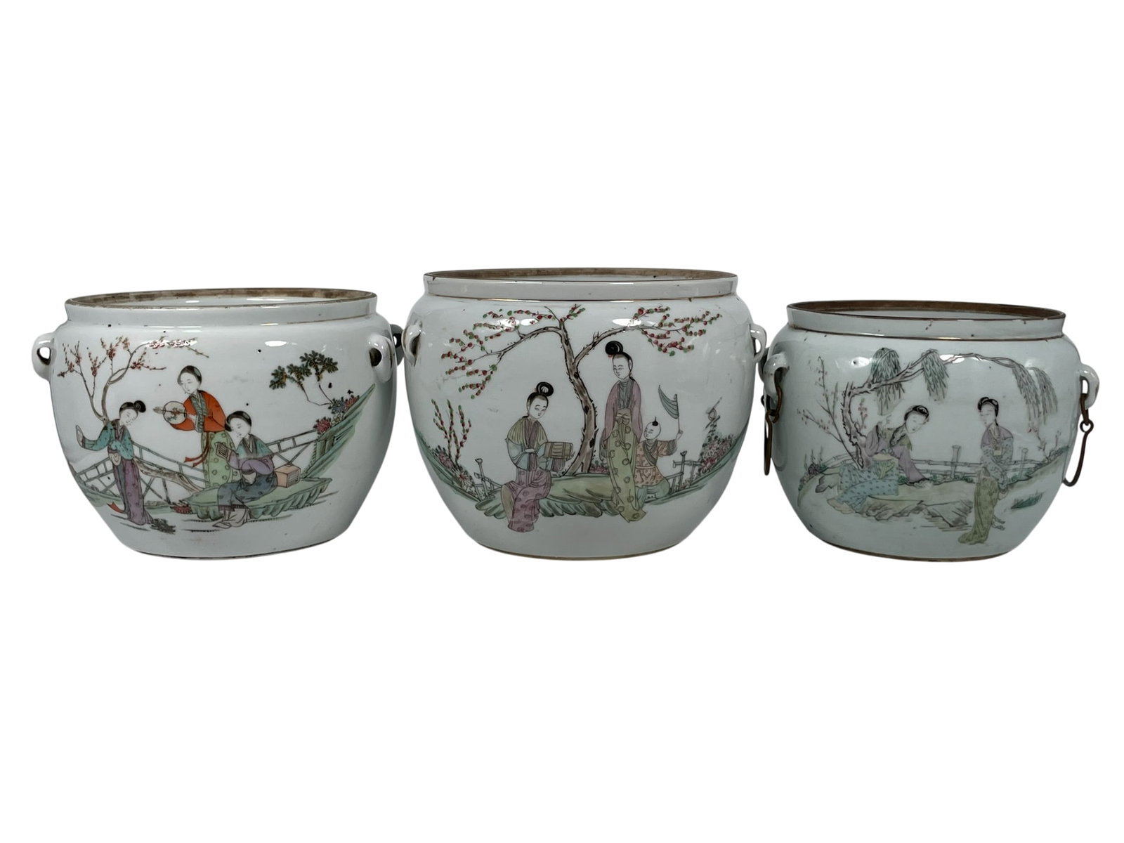 A Group of Three Chinese Famille Rose 'Ladies' Jars, Late Qing Dynasty/Republic Period: No covers. One jar with a signature Wan Bingqing on one side and a mark to the bottom, 5.1/8 in. high, 7.1/4 in. wide; one jar with a signature Liu Haisheng on one side and a mark to the bottom, 5.7/8