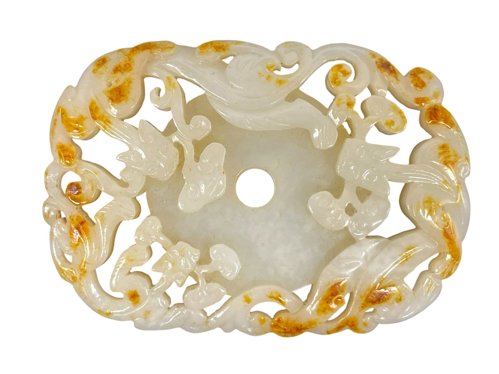 A Chinese Carved and Reticulated White and Russet Jade Plaque: 3 in. long, 2.1/8 in. wide.