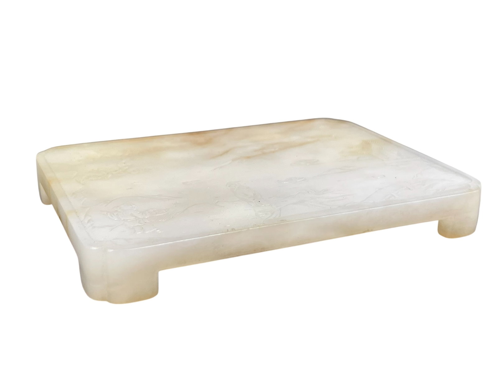 A Chinese Carved White and Russet Jade Stand: The jade stand measures 1/2 in. high, 4 in. wide. Japanese wood box.