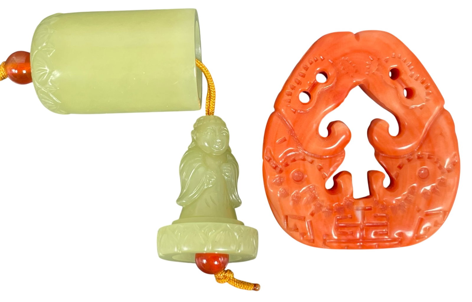 Two Pendants, Jade and Coral: The jade pendant measures 1.1/4 in. high, 3/4 in. diam. overall; the coral pendant measures 1.5/8 in. high, 1.1/2 in. wide.