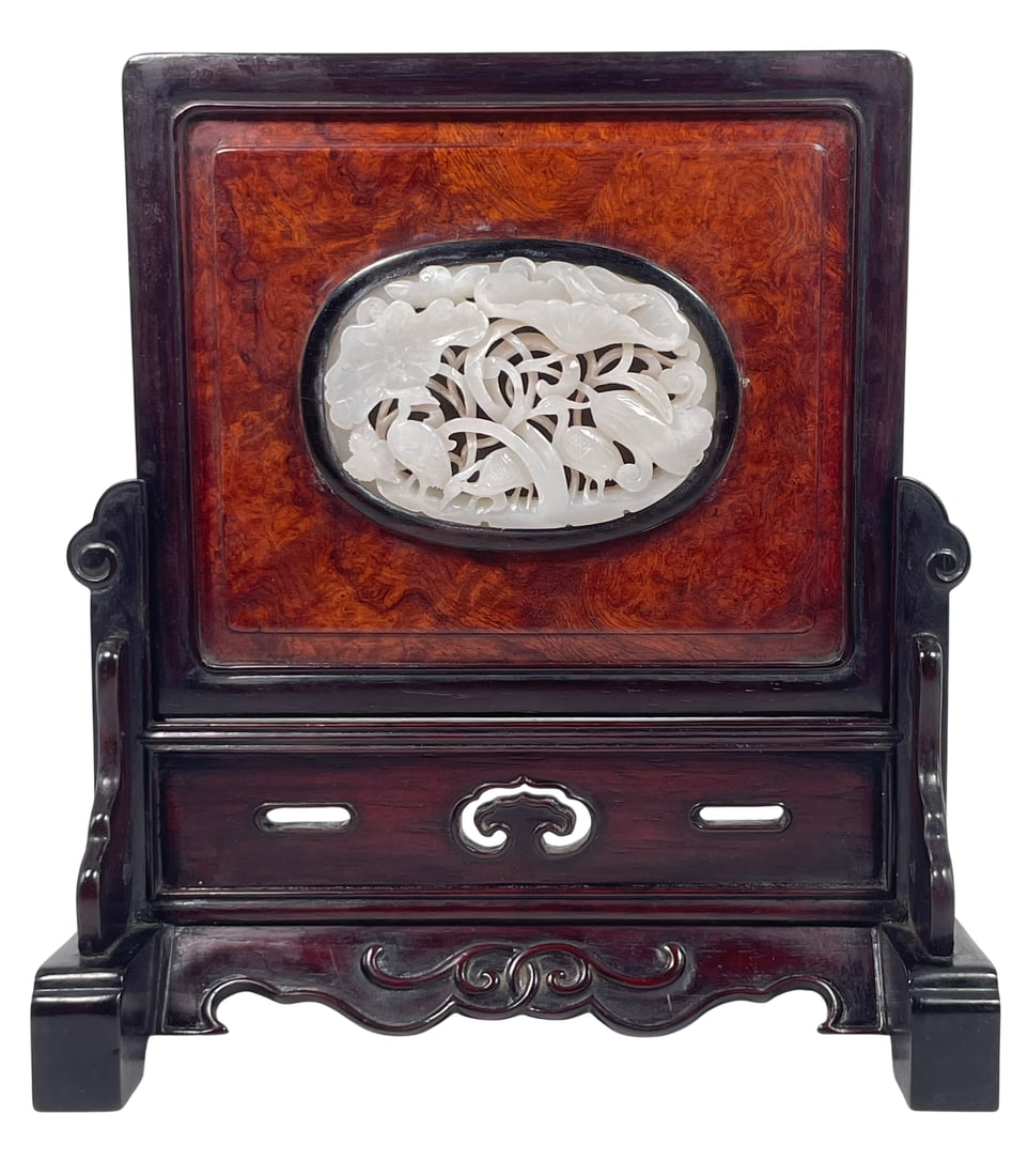 A Chinese Reticulated White Jade Plaque Inset Burl-Wood Table Screen: 3.1/4 in. long, 2.1/4 in. wide for the jade plaque; 8.3/8 in. high, 7.1/2 in. wide overall for the table screen.