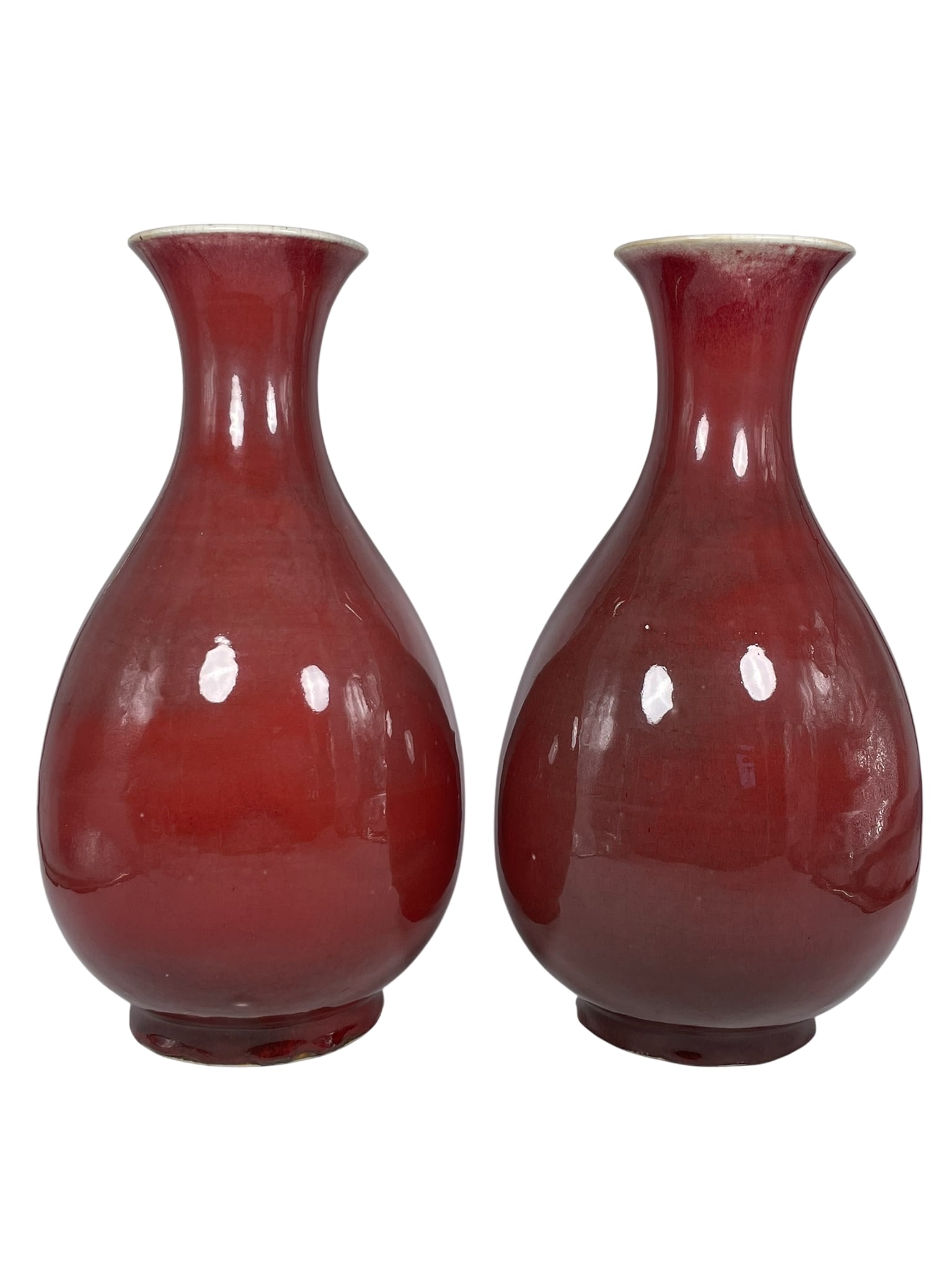 A Pair of Chinese Red-Glazed Vases, Yuhuchunping, Mid-Qing Dynasty: 16 in. high, 8.1/4 in. wide each.