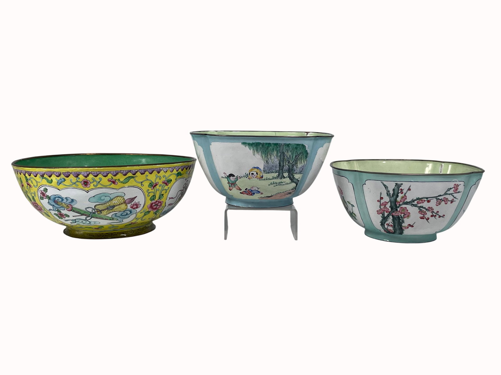 A Group of Three Chinese Painted Enamel Bowls: Comprising a larger 'peach' bowl, 3.7/8 in. high, 9 in. diam.; a smaller 'peach' bowl, a maker's mark 'yi he cheng zhi' to the bottom, 3.1/2 in. high, 7.1/4 in. wide; a 'bird' bowl, 3.1/2 in. high, 7.