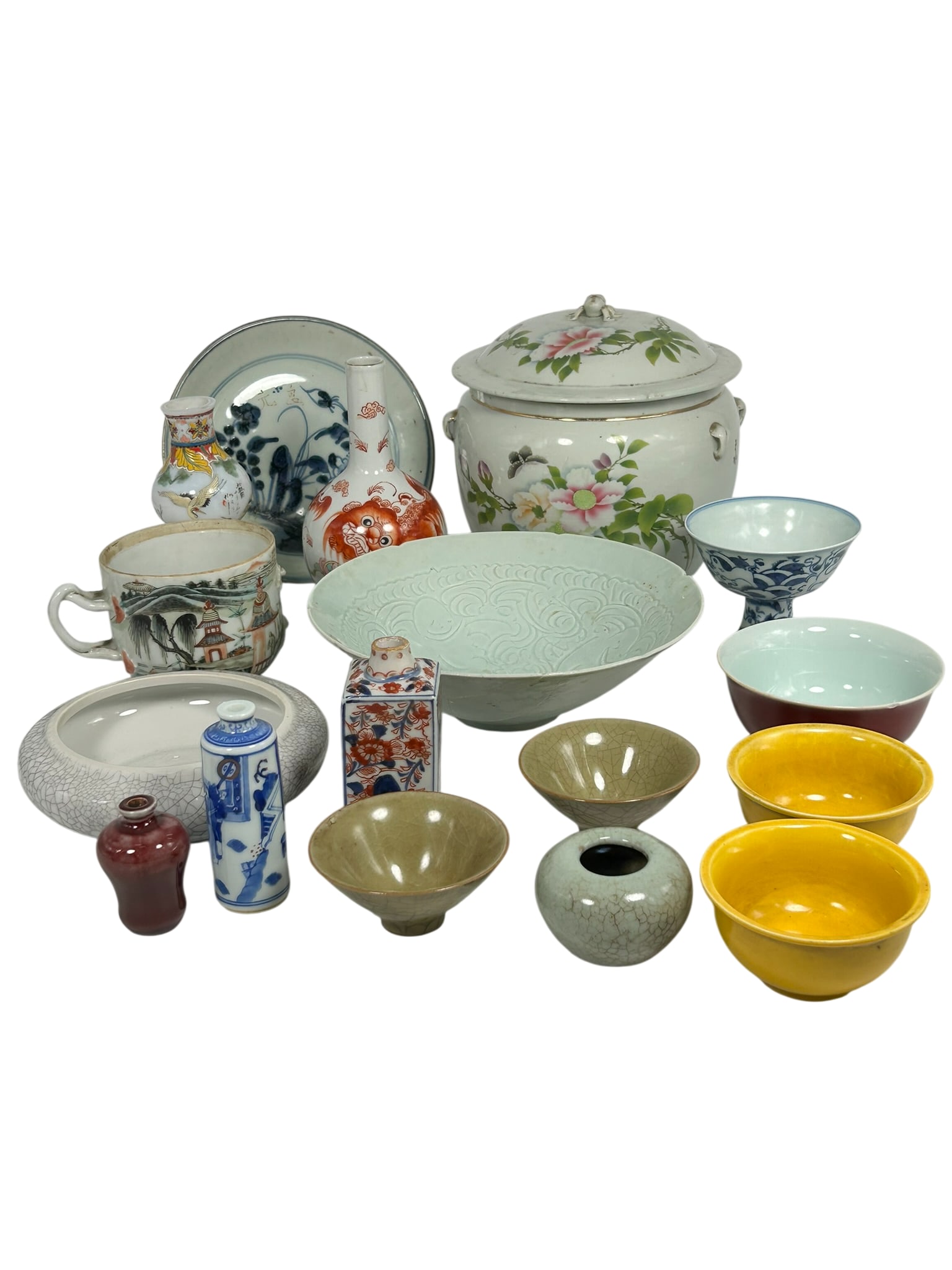A Group of Seventeen Asian Porcelain Ware: Comprising a famille rose jar and cover; a blue and white dish; a carved qingbai dish; a crackle-glazed water pot; an iron-red and green decorated 'Buddhist lion'vase; a famille rose double gourd vase