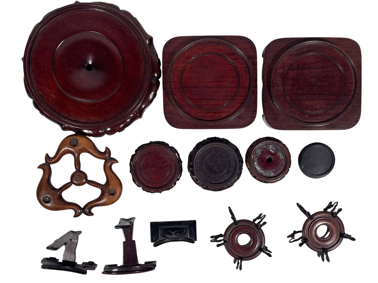 A Group of Thirteen Chinese Wood Stands: The largest measures 2.1/2 in. high, 11 in. diam.