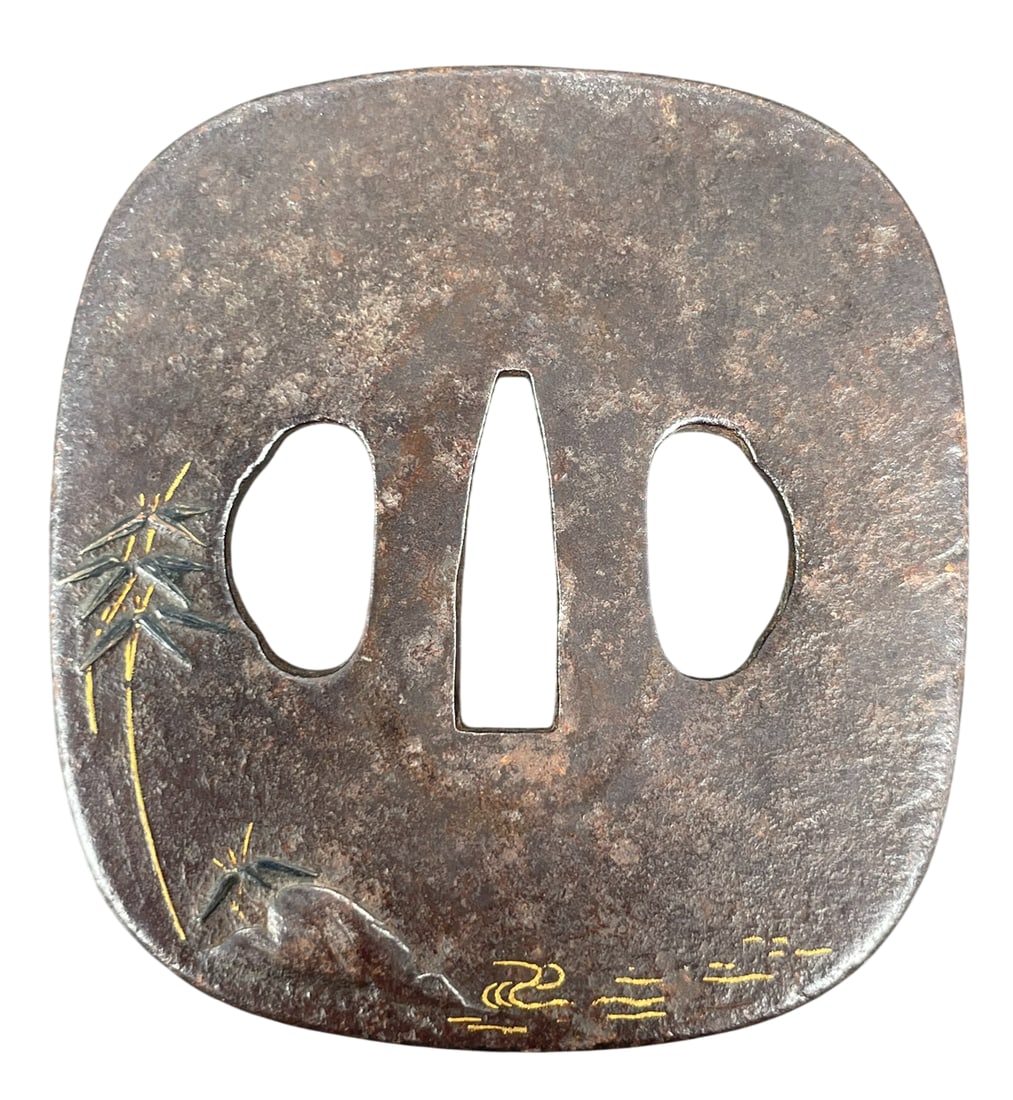 A Japanese Iron Tsuba with Silver and Gold Inlay: 2.7/8 in. long, 2.3/4 in. wide.