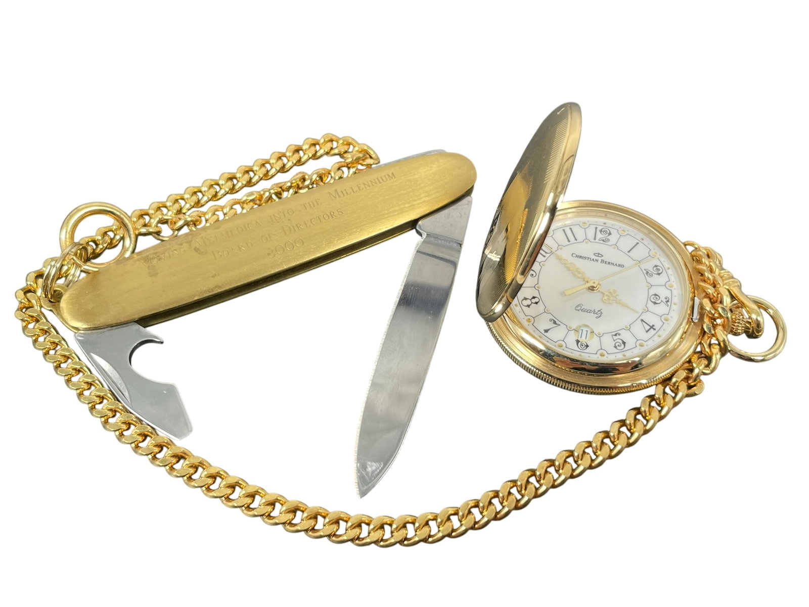 A Gold-Tone Christian Bernard Quartz Pocket Watch: Together with a pocket knife. The watch dial measures 1.5/8 in. diam.