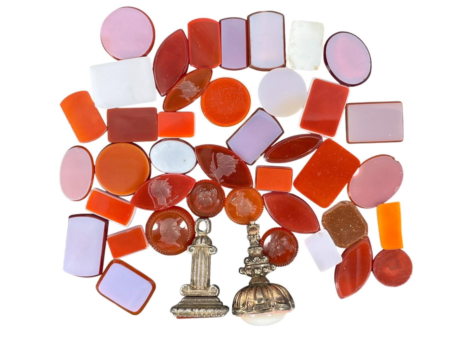 A Group of Forty-Two Agate and Glass Objects: Comprising a group of eleven Roman carnelian agate seal intaglios in circular or oval shape, with largest measures 7/8 in. long, 3/8 in. wide; a group of twenty-nine glass mosaic tiles, with the