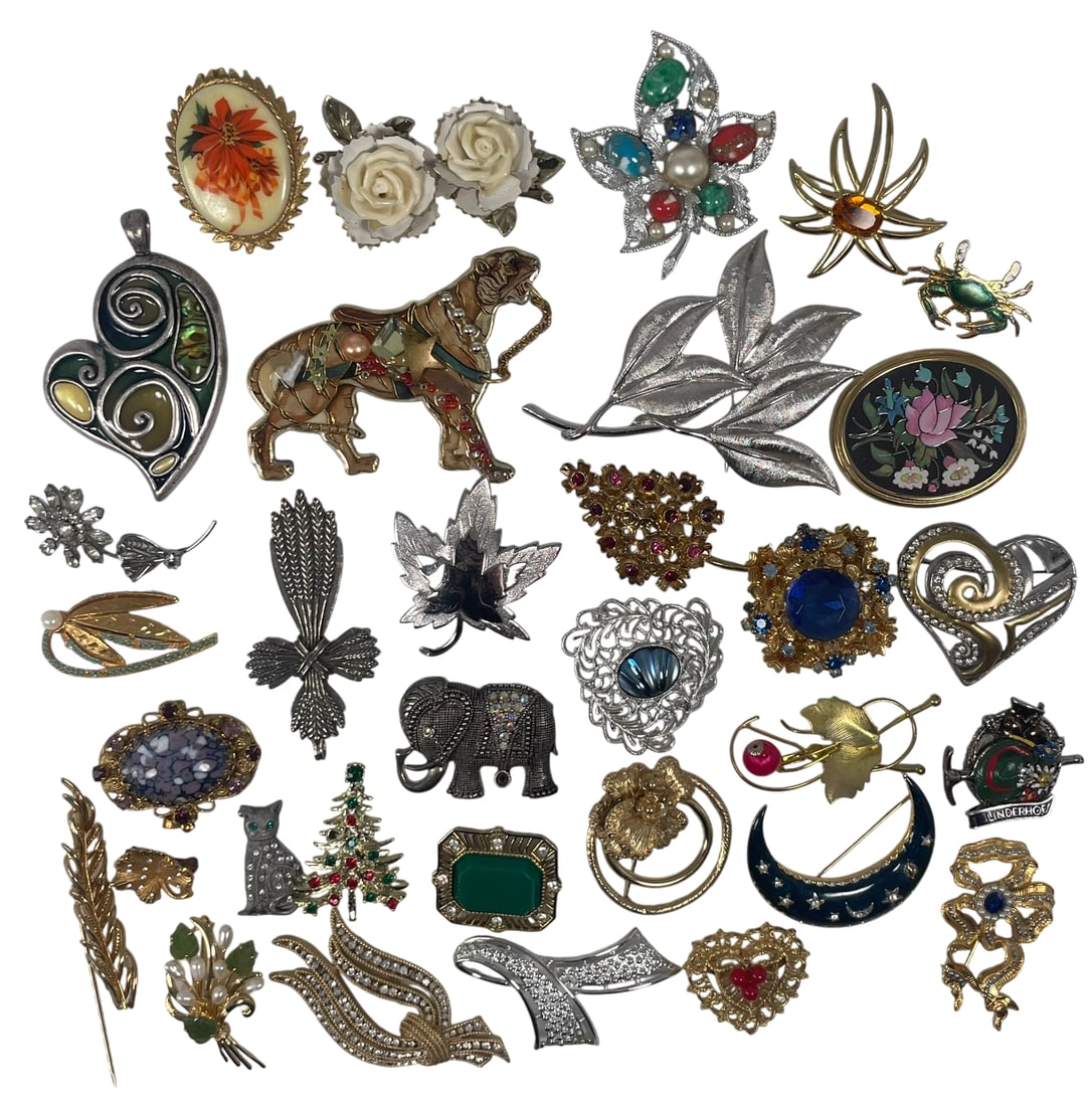 A Vintage Costume Jewelry Collection of Thirty-Three Brooches: Features an array brooches in various floral, animal, and abstract designs. The largest measures 3.3/4 in. long, 3 in. wide.