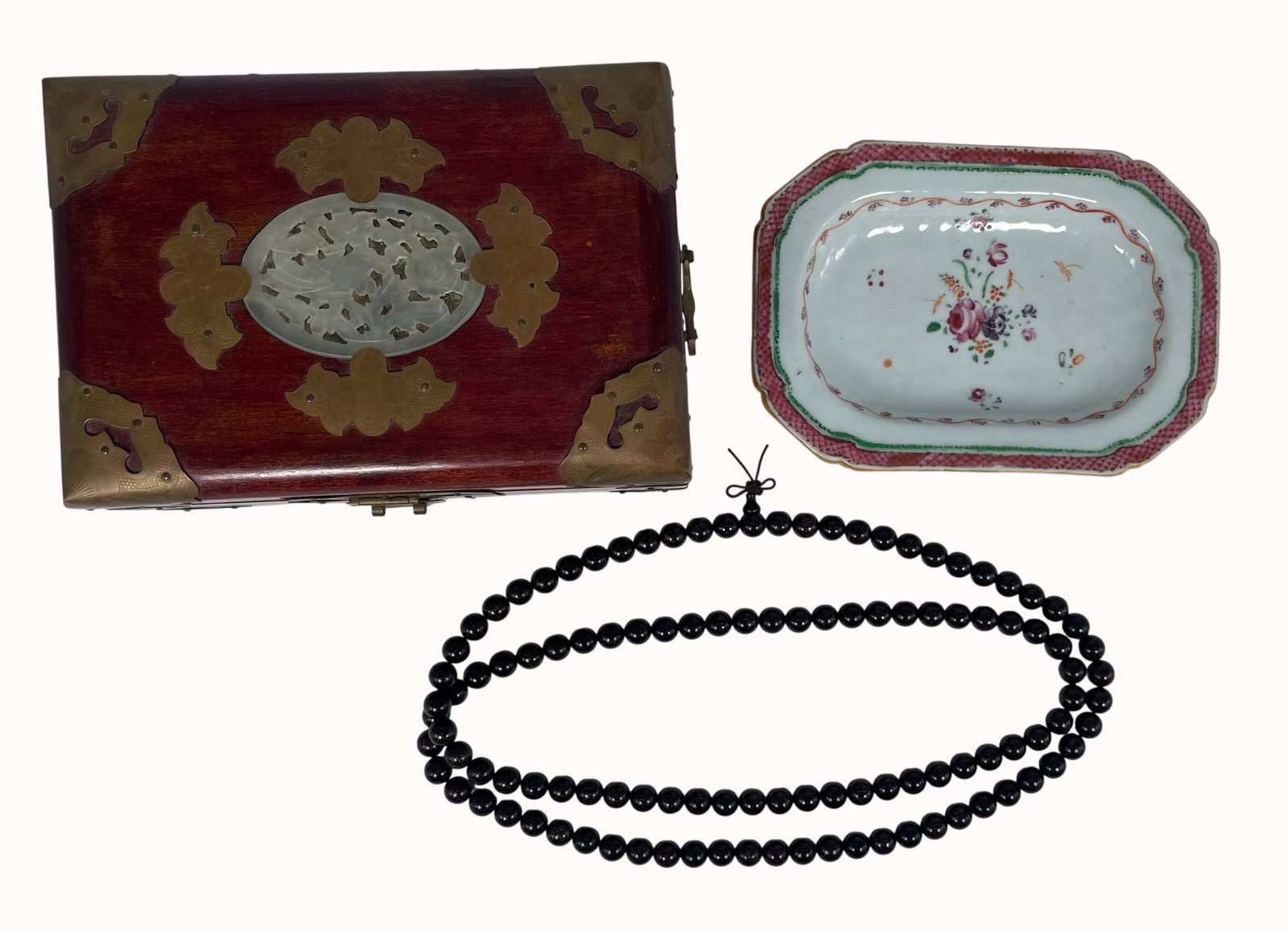 A Group of Three Chinese Decorative Objects: Comprising a jade plaque-inset wood trinket box, 4.1/4 in. high, 7.1/2 in. wide, 5.1/2 in. deep; a famille rose porcelain dish, 7.1/4 in. long, 5.1/8 in. wide; and a strand of wood beads, 48 in. long 