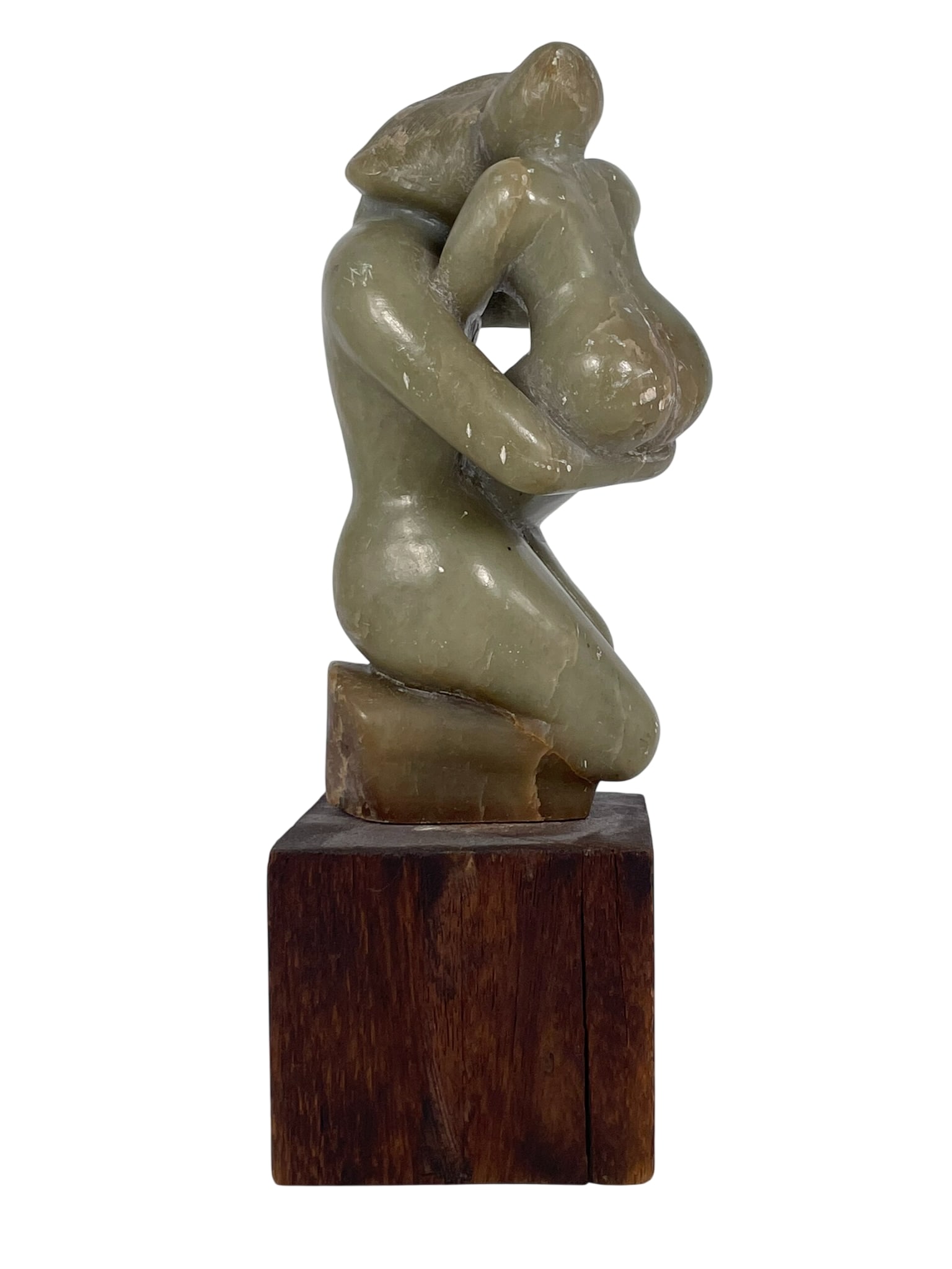 A Carved Abstract Carved Green Stone Sculpture: Mounted on a square wood base. 11.1/4 in. high, 4.1/2 in. wide.