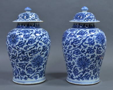 Two Large Chinese Blue & White Vases: With covers. Likely Kangxi Period (1654-1722). Painted in deep cobalt blue with boldly scrolling lotus. 16" H. to top of finial. One lid has been broken and glued with some edge loss. One vase has min