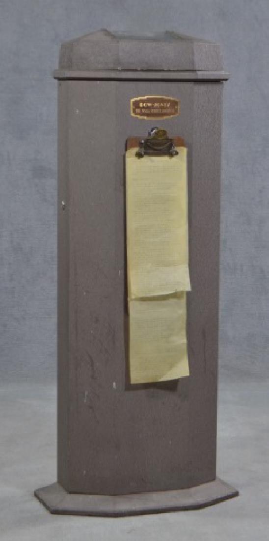 Vintage Ticker Tape Machine: c. 1940. Metal case holds ticker tape machine at top. Having lid with glass window and clipboard on front. Clipboard retails 2 pages of printed stock information, to include "Dow Jones Averages" and "