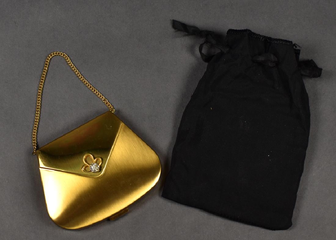 Vintage Volupte Compact, Gilt Metal Purse Form: Vintage Volupte compact, purse form, gilt metal having a rhinestone design and gilt metal chain, powder puff and compact marked Volupte, 2.75"h x 3.5"w.
