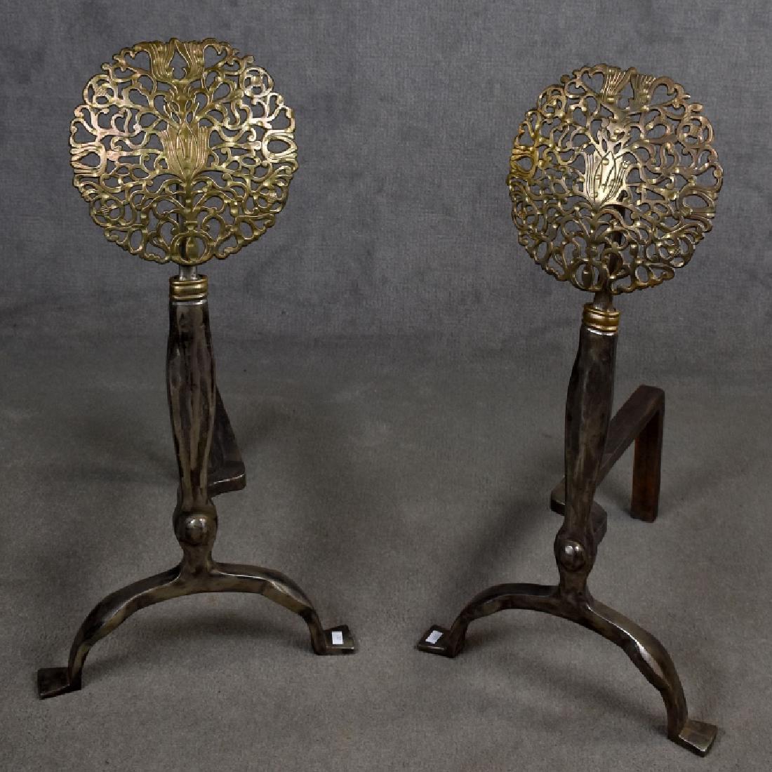 Pair of Tulip / Sunburst Andirons Attributed Bach: Polished steel andirons having a 8.5" diameter pierced metal floral design rising from the base, attributed to Oscar Bruno Bach, reverse side of feet marked "001", overall very good condition, 27"H x 