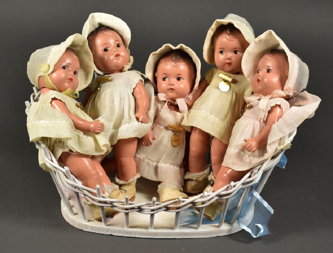 Toddler Set of 5 Dionne Quintuplets in Composition: Composition is excellent. All with brown painted eyes and hair. All 5 dolls have their original dress, undies, hat, shoes, and socks. All have gold colored pin with name. All marked "Alexander" on hea