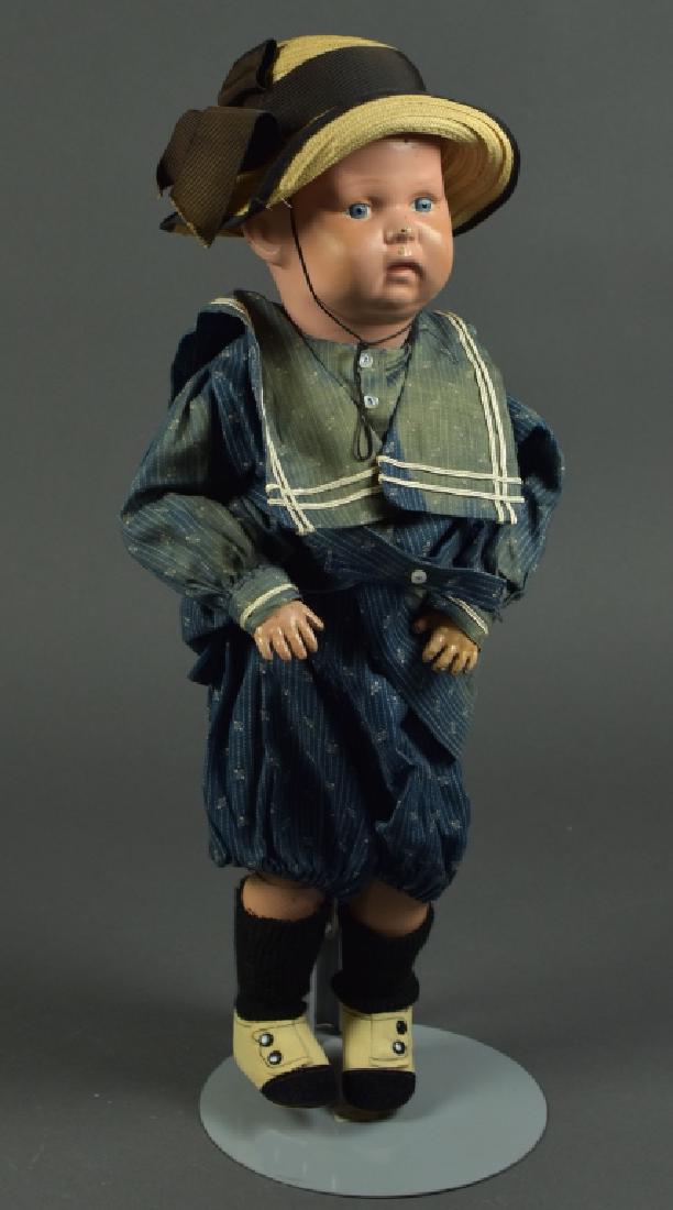 American Schoenhut Dome Head Toddler Boy: 17". Blue painted eyes, painted hair. Stamped hair and body. Antique clothing and hat. Good to excellent.