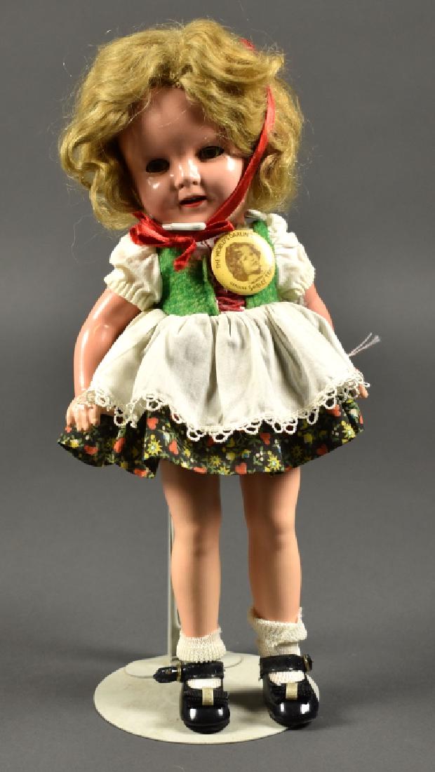Ideal Composition Shirley Temple: With original Heidi outfit and pin. Composition is excellent with crazing. Some paint touch up on fingers. Original mohair wig. 13" H.