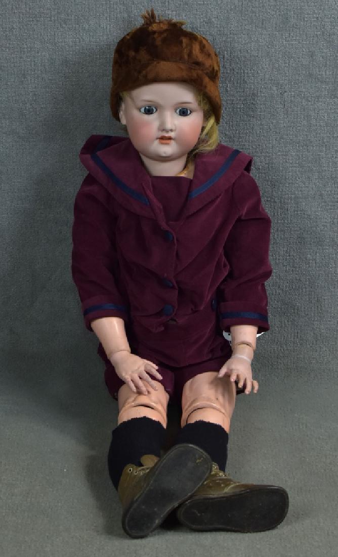 Armand Marseille 390 Boy Blue: 34". Set stationary eyes, open mouth-teeth. Composition and wood ball jointed body with original finish. Neck repairs. Mohair wig and dressed in antique burgundy velvet suit, socks and shoes.