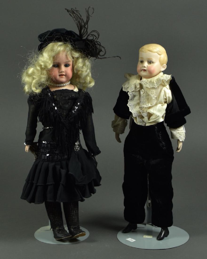 German Bisque Shoulderhead School Boy: Marked "30 BG" and "RMB" in black china paint. Shoulderhead boy with molded blonde hair, painted brown eyes, and closed mouth. Bisque lower arms and feet. Cloth stuffed body. Dressed in antique black