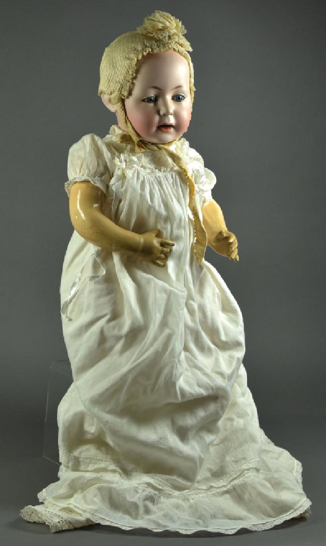 German Swaine & Co Dome Head Character Baby "Lori": 23". Mold #232. Blue sleep eyes, open mouth, dome head with painted hair. Composition five piece bent limb baby body. Very nice antique clothing and underwear. One pinky is damaged.