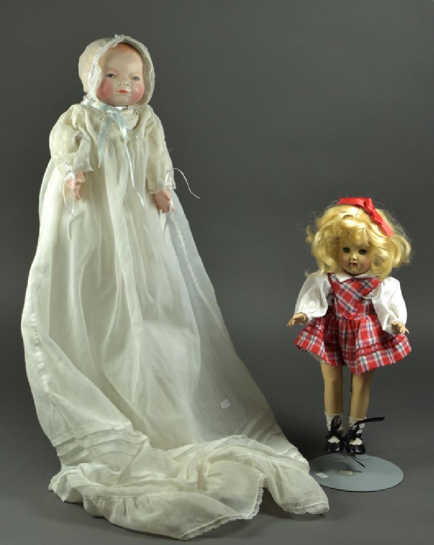 German Bisque Bye-Lo Baby by Grace Putnam: 16" H. 12 1/2" head circumference. Blue sleep eyes, replaced porcelain hands, new cloth body. Dressed in newer cotton christening gown and undies. Head has a piece broken out of the back that has been