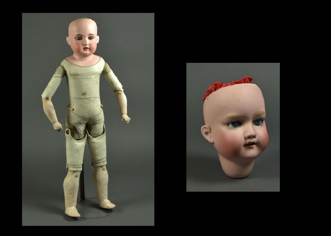 German Armand Marseille Shoulderhead #370: 24". Blue set eyes, open mouth. Kid leather pin jointed body with lower composition arms and legs. Hairline crack on forehead, fingers damaged. Also a 7" Japanese Nippon head. 13" head circumference, 