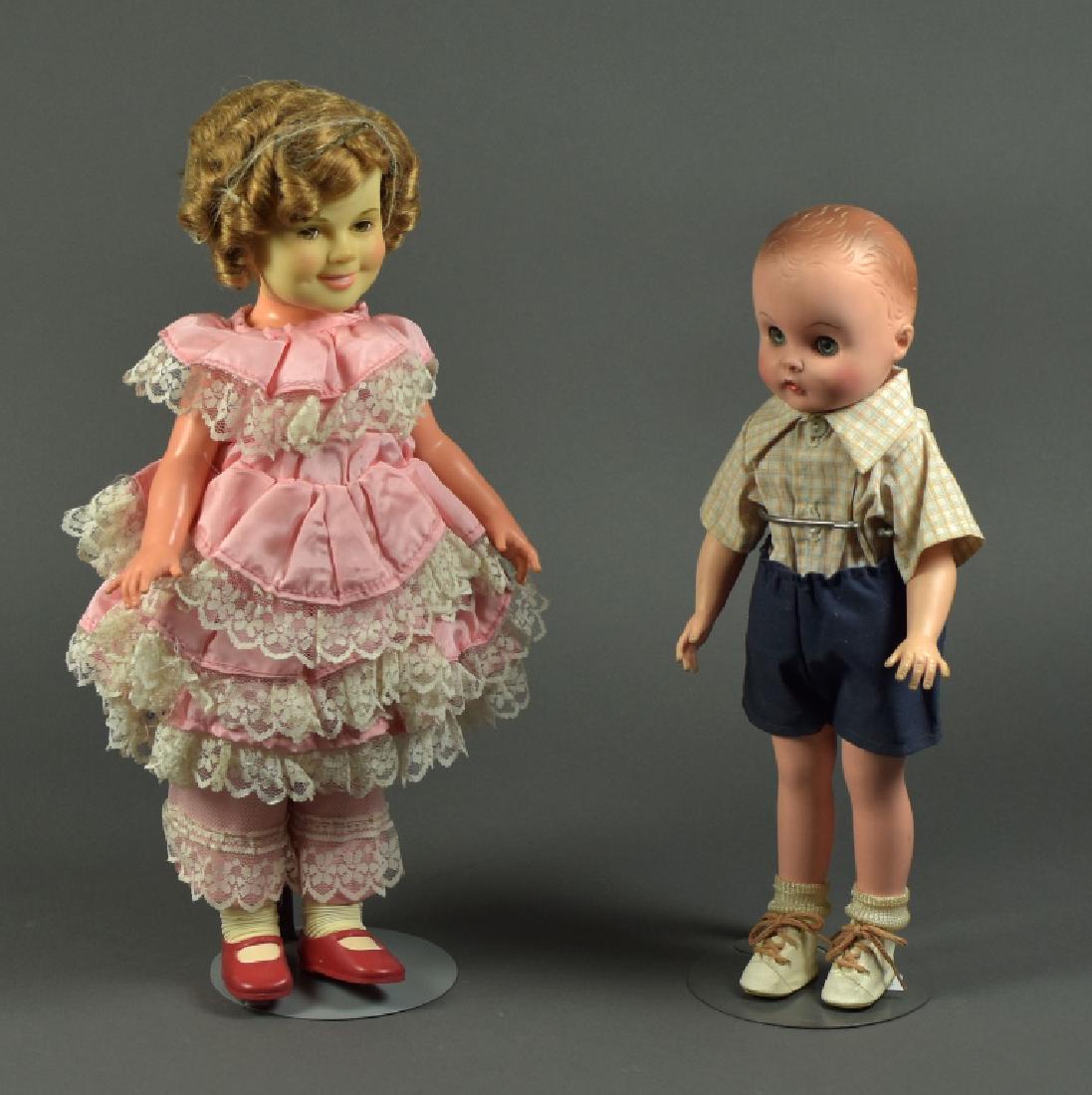 1972 Ideal "Shirley Temple": Vinyl and hard plastic with original hair set. Dressed in original clothing. 16" H. Along with a 14" dressed vinyl and hard plastic doll with sleep eyes.