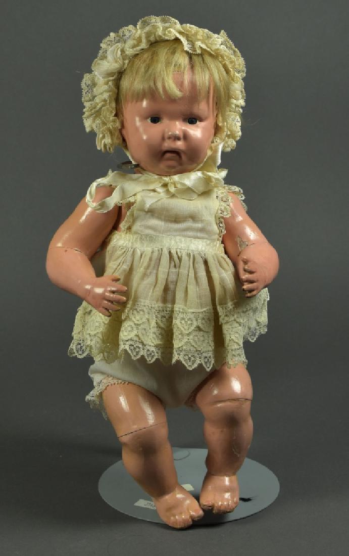 American Schoenhut Character Baby: 16". Marked H.E. Schoenhut 1913. Blue painted eyes, open close mouth; original mohair wig, replaced clothing/. Very good condition with moderate scuffs.